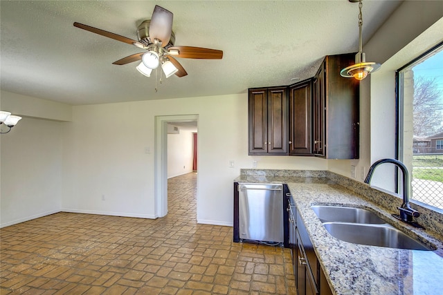kitchen with baseboards, a sink, a ceiling fan, dark brown cabinetry, and stainless steel dishwasher