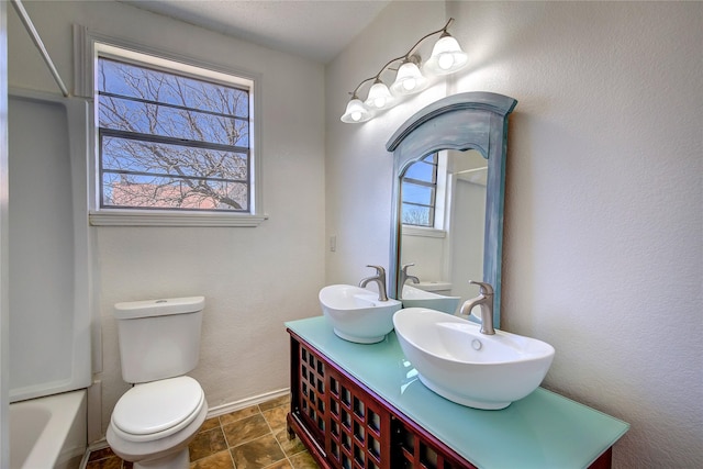 bathroom with plenty of natural light, a sink, and toilet