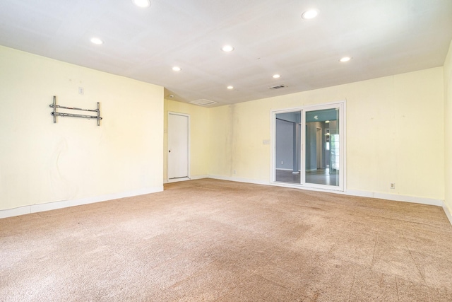 carpeted empty room with visible vents, baseboards, and recessed lighting