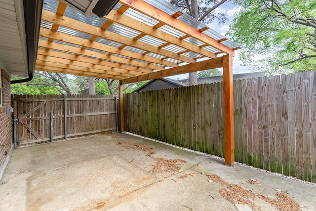 view of patio featuring a carport and fence