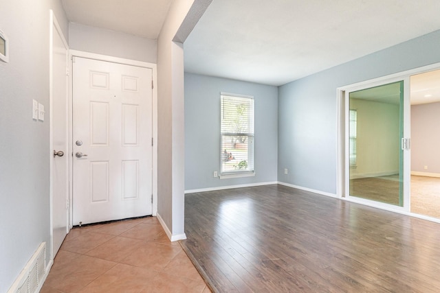 foyer with visible vents, baseboards, and light wood-type flooring
