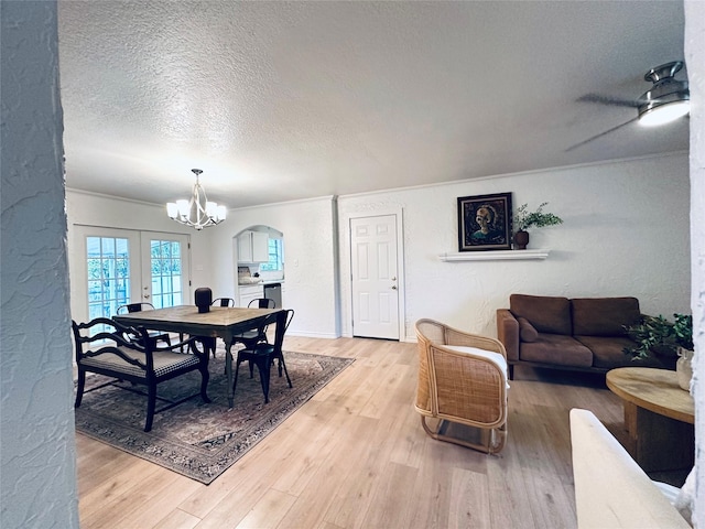 1317 N Mary St, Comanche, TX 76442 - kitchen with arched walkways, stove, light wood-style flooring, white cabinets, and light stone counters
