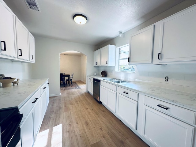 1317 N Mary St, Comanche, TX 76442 - kitchen with dishwashing machine, a sink, dark wood-style flooring, tasteful backsplash, and white cabinets