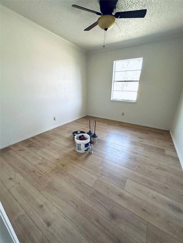 1317 N Mary St, Comanche, TX 76442 - unfurnished room featuring ornamental molding, a textured ceiling, hardwood / wood-style floors, and baseboards