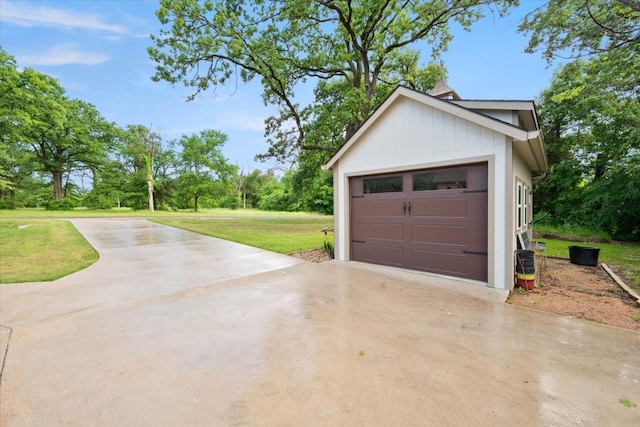 garage featuring concrete driveway