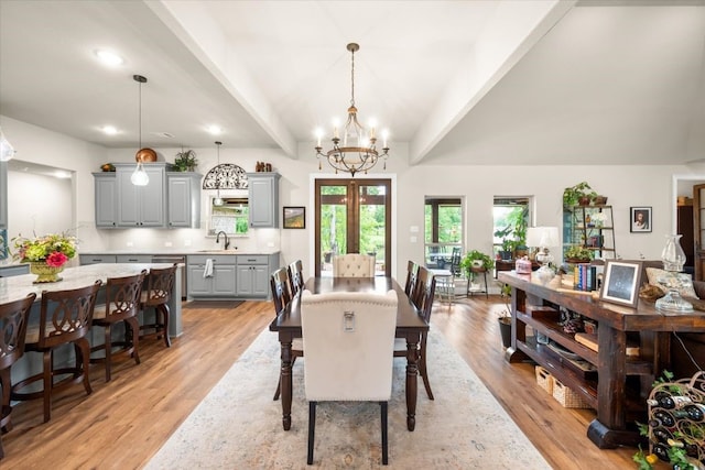 dining area featuring recessed lighting, light wood-style flooring, a chandelier, and beam ceiling