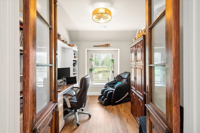 office area featuring visible vents, light wood finished floors, and baseboards
