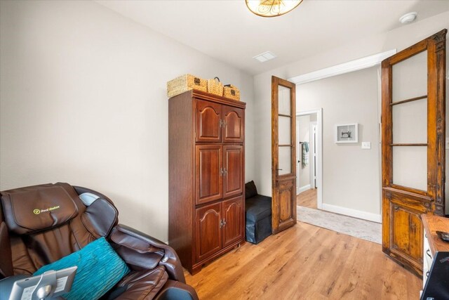 living area with visible vents and light wood-style flooring