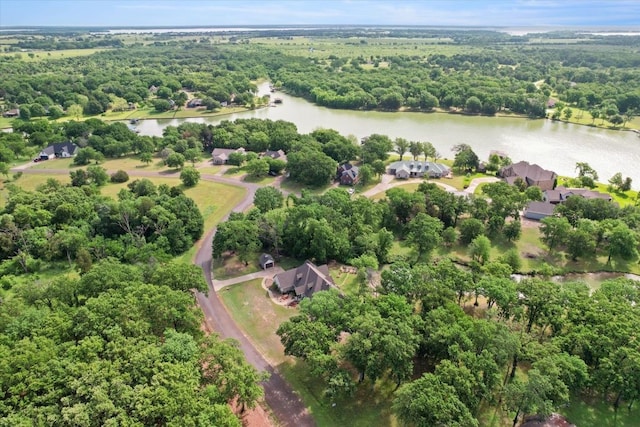 birds eye view of property with a water view and a view of trees