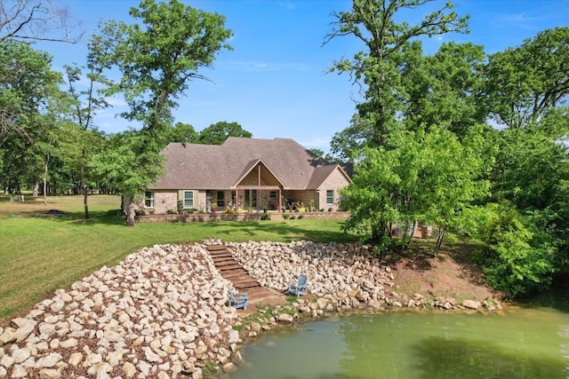 rear view of house with a yard