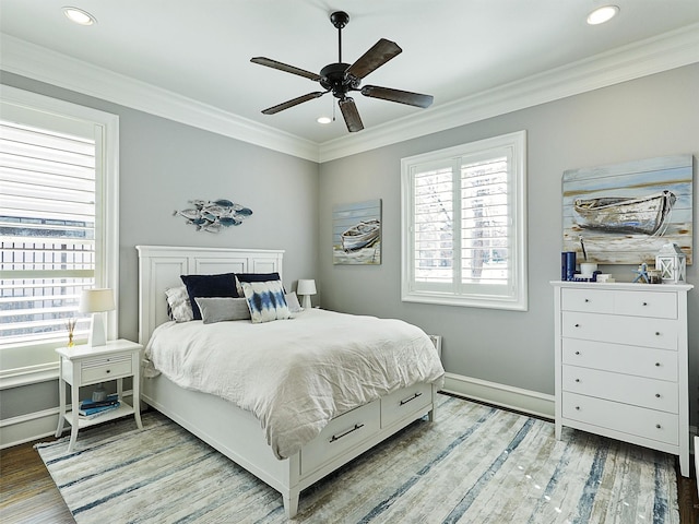 bedroom with recessed lighting, wood finished floors, baseboards, and ornamental molding