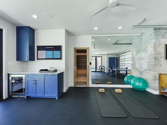 workout area featuring recessed lighting, beverage cooler, baseboards, and ceiling fan