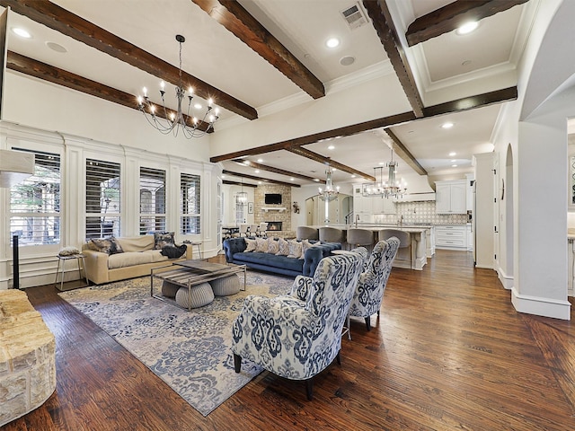 living room featuring beamed ceiling, visible vents, a notable chandelier, and dark wood-style flooring