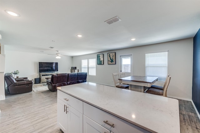 kitchen with ceiling fan, visible vents, white cabinetry, recessed lighting, and light wood-style flooring