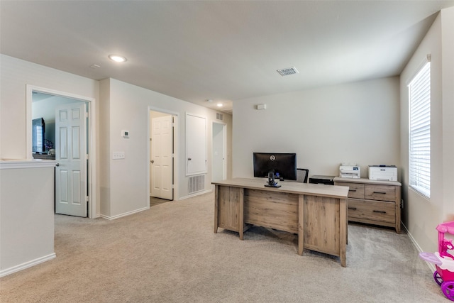 office space featuring baseboards, light carpet, recessed lighting, and visible vents