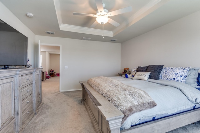 bedroom featuring crown molding, a tray ceiling, visible vents, and light carpet