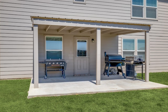 property entrance featuring a lawn and a patio area