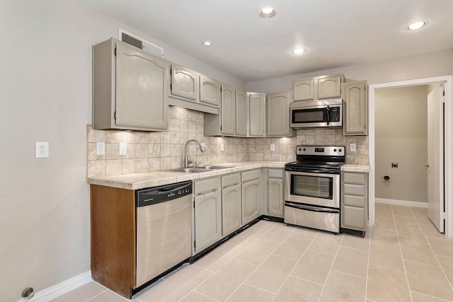 4248 Ireland Dr, The Colony, TX 75056 - kitchen featuring stainless steel appliances, tasteful backsplash, light countertops, and a sink