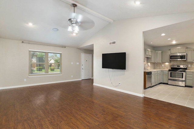 4248 Ireland Dr, The Colony, TX 75056 - unfurnished living room with light wood-style flooring, lofted ceiling with beams, a sink, and a ceiling fan