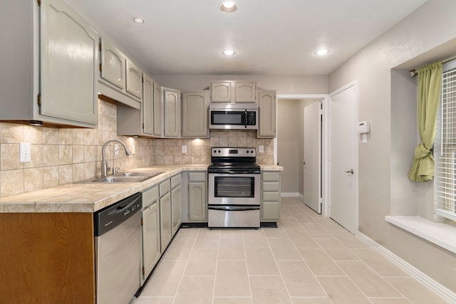 4248 Ireland Dr, The Colony, TX 75056 - kitchen featuring recessed lighting, light tile patterned floors, backsplash, appliances with stainless steel finishes, and a sink