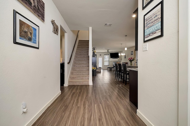 7632 Parkview Dr, Watauga, TX 76148 - corridor with baseboards, dark wood-type flooring, and stairway