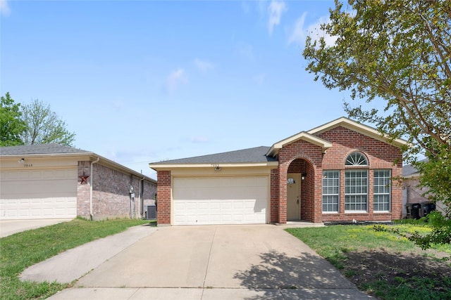 single story home featuring concrete driveway, brick siding, central AC, and an attached garage