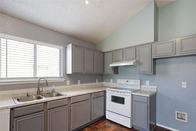 kitchen featuring gray cabinetry, white appliances, a textured ceiling, and a sink