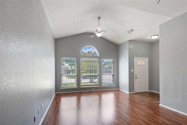 entrance foyer with a textured wall, visible vents, ceiling fan, and wood finished floors