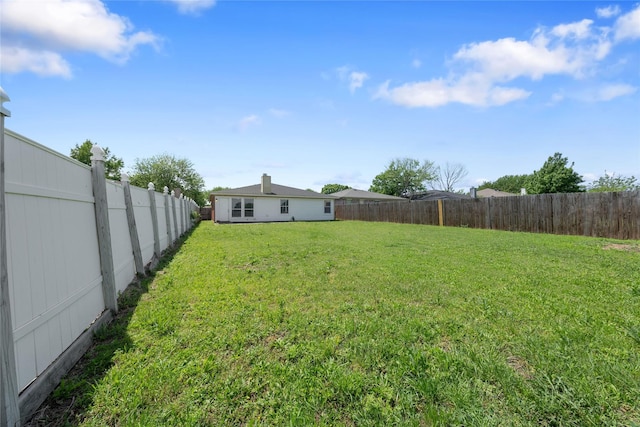 view of yard with a fenced backyard