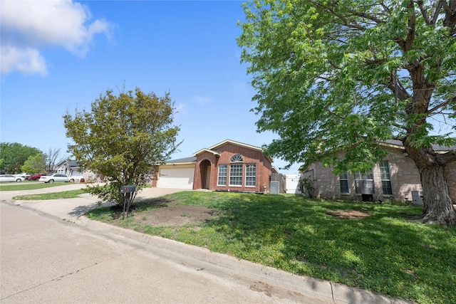 view of front of property featuring a garage, concrete driveway, a front lawn, and brick siding