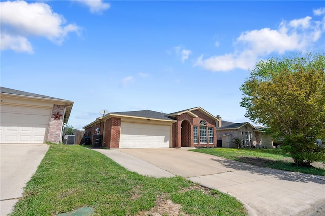 ranch-style house featuring a front yard, brick siding, an attached garage, concrete driveway, and central AC unit