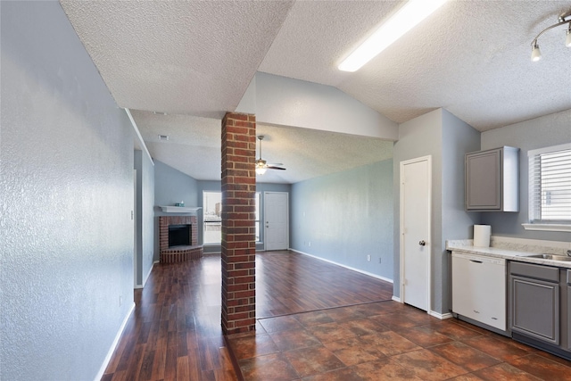 kitchen with gray cabinets, dishwasher, a ceiling fan, and lofted ceiling