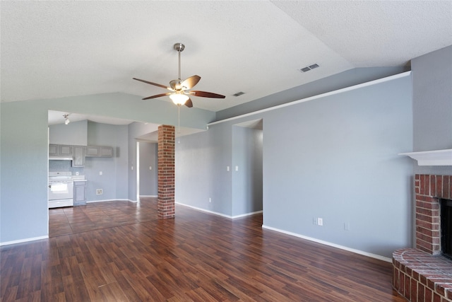 unfurnished living room with dark wood-style flooring, a ceiling fan, vaulted ceiling, and a fireplace
