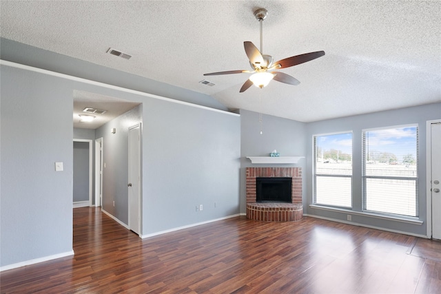 unfurnished living room with a ceiling fan, lofted ceiling, wood finished floors, and a textured ceiling