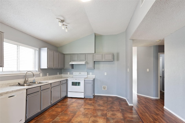 kitchen featuring gray cabinets, white appliances, a textured ceiling, under cabinet range hood, and a sink