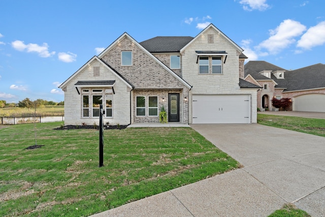 view of front of house featuring a front yard, stone siding, a garage, and driveway