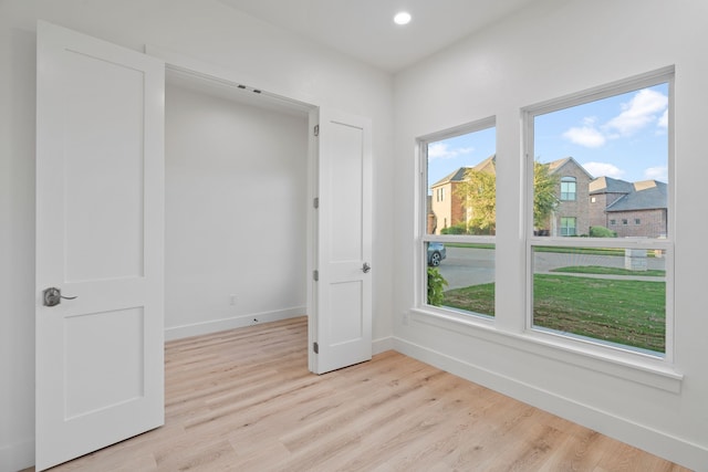 unfurnished room with recessed lighting, light wood-style flooring, and baseboards