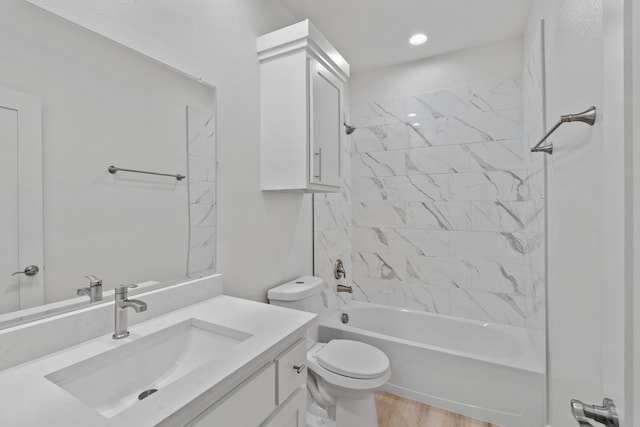 full bath with shower / bath combination, vanity, toilet, and wood finished floors