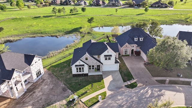 drone / aerial view with a residential view and a water view