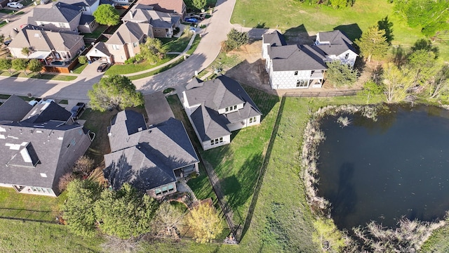 drone / aerial view with a residential view and a water view