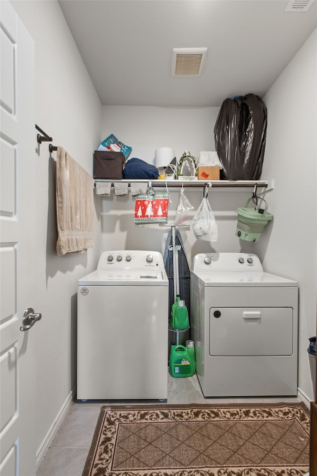 1703 Ratama Dr, Princeton, TX 75407 - laundry room with washer and clothes dryer and light tile patterned floors