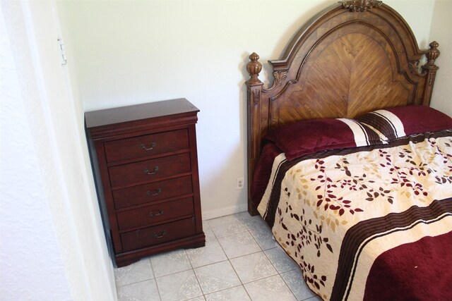 bedroom with light tile patterned floors
