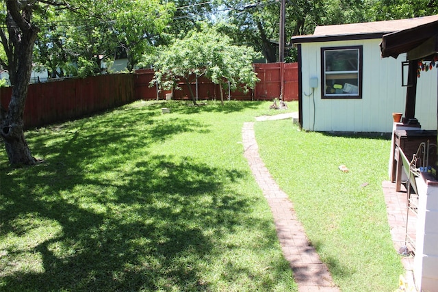 view of yard with an outbuilding and a fenced backyard