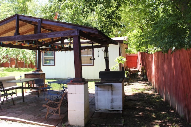 view of patio / terrace with a gazebo, a fenced backyard, and outdoor dining area