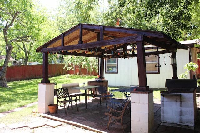 view of patio featuring a gazebo, outdoor dining area, and a fenced backyard