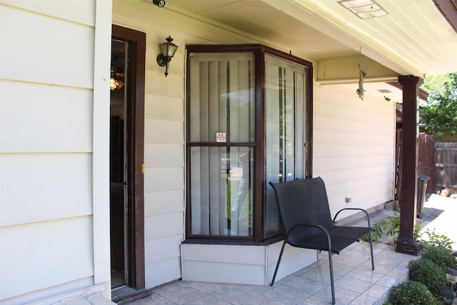 view of patio with a porch and fence