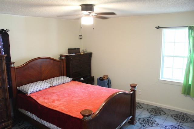 bedroom with baseboards, multiple windows, and ceiling fan