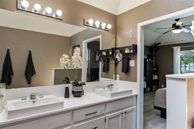 ensuite bathroom with ceiling fan, ensuite bath, a sink, and double vanity