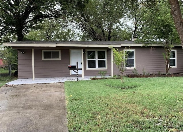 ranch-style home featuring a front yard and fence