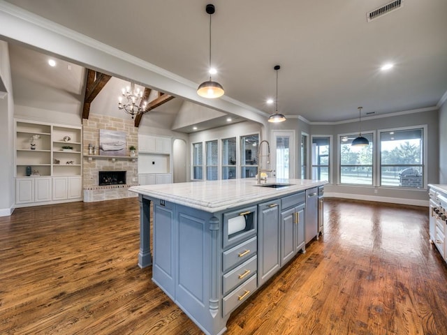 kitchen with a sink, dishwasher, a chandelier, open floor plan, and visible vents